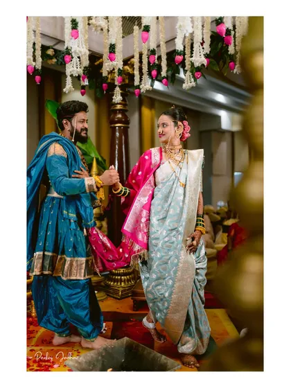 A beautifully framed shot of the couple during their wedding rituals.