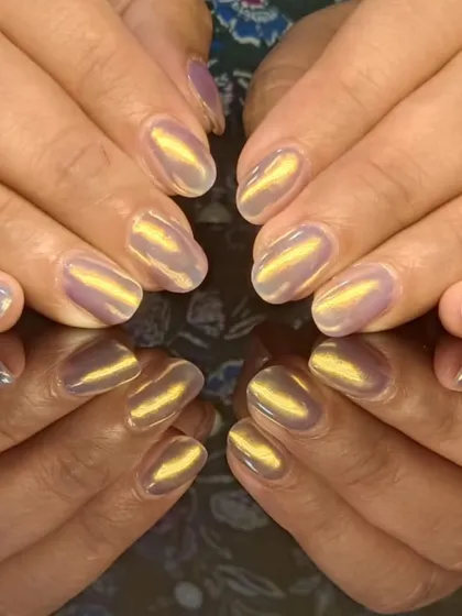 A unique cat-eye design with a golden shimmer over a light purple base, creating a magical, iridescent look.