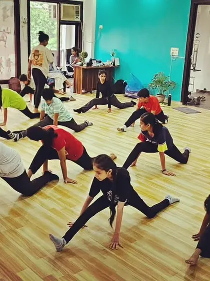 Students in our jazz class working on flexibility and floor work, an essential part of modern dance training.