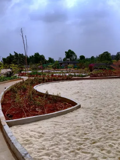 The sand pit and swing set at 'The Sanctuary' taking shape, with the curved concrete edging defining the play space.