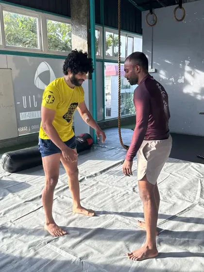 Brotherhood, integrity, and development. Drilling techniques with a teammate on the mats.