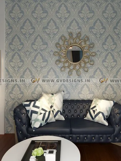 A closer look at the retro sitting area in the vintage-inspired bedroom. The tufted blue sofa is set against a classic damask wallpaper and accented with a sunburst mirror, creating a cozy and stylish corner for relaxation.