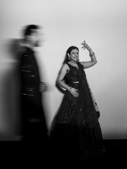 A beautiful black and white version of the artistic motion blur portrait, emphasizing the bride's graceful dance pose.