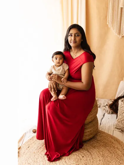 A mother and her child share a moment in a bright, boho-chic setting. A beautiful example of a relaxed and modern family portrait.