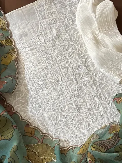 A detail shot of the Chikankari kurta fabric, showing its dense jaal work, paired with the Kalamkari dupatta.