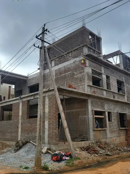 A clear view of the construction progress, with brickwork completed for the lower floors.