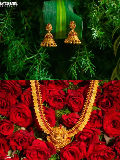A stunning detail shot of the traditional gold wedding jewelry, beautifully arranged on a bed of red roses.