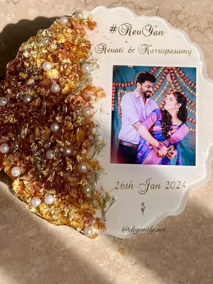 Capture your special moment for eternity. This photo frame features intricate varmala designs on one side and an unforgettable photo on the other.