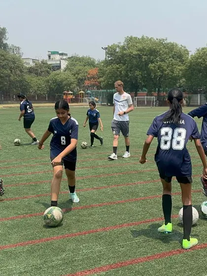Our girls' team participates in a drill led by a VfB Stuttgart coach. We provide equal opportunities and world class training for our female athletes, exposing them to international training methodologies.