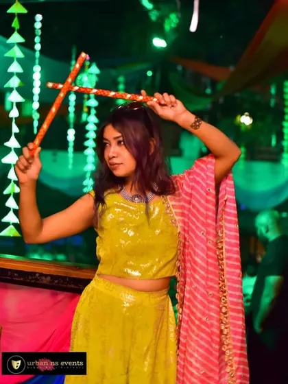 Posing with the dandiya sticks. I'm always ready to join in on the fun and dance along with the crowd.