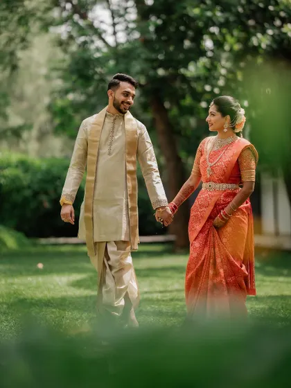 A quiet, intimate portrait framed by lush greenery. We use natural elements to create a sense of romance and tranquility in our couple's wedding photos.