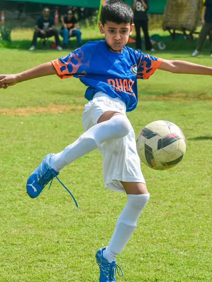 Here, we focus on mastering the fundamentals. This young player demonstrates excellent ball control and kicking technique, skills we build in every session.