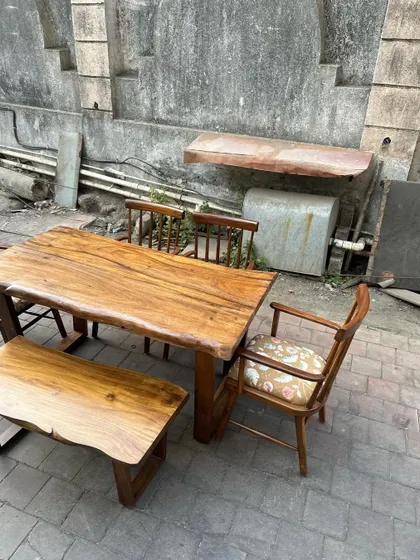 A close-up of the live-edge bench and table, highlighting the sturdy base and rustic charm.