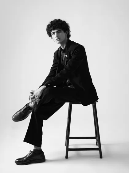 A classic, full-length black and white portrait for a commercial or fashion portfolio. The pose is confident and timeless.