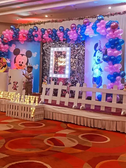Another angle of the birthday stage, showing the white picket fence detail and balloon columns. These small touches add depth and complete the themed look.