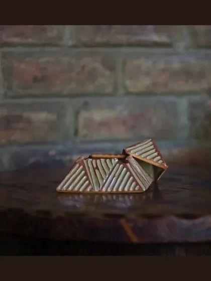 These unique, pyramid-shaped lidded boxes are also part of the KHUMĀR collection, perfect for storing small items or just as a decorative piece.