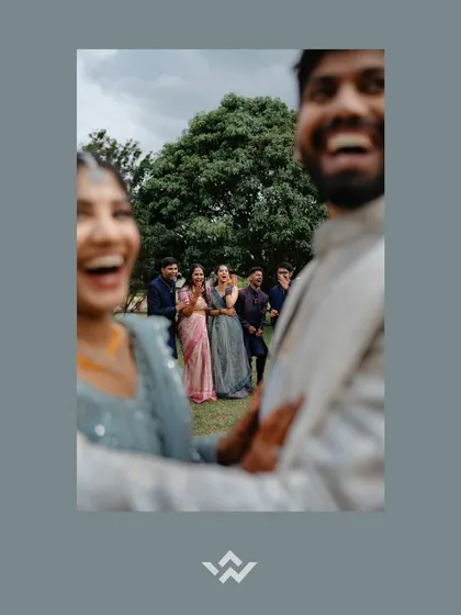 A candid, out-of-focus shot of a couple laughing with their friends. This artistic choice captures the feeling and energy of the moment rather than just a perfect pose.