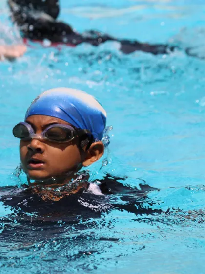Action shots from our kids' classes, showing students practicing different strokes and building their endurance in the water.