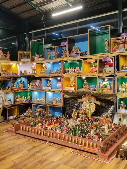 A section of the doll display, with each box containing a carefully arranged scene from our mythology. The lighting and arrangement bring these static dolls to life.