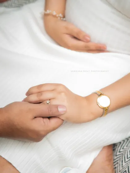 A simple, powerful close-up of a couple holding hands, symbolizing their partnership and shared journey into parenthood.
