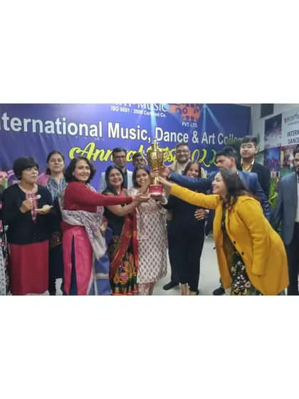 Our dedicated faculty and staff come together to celebrate a successful event. This group photo shows the team holding a trophy, representing our collective effort and commitment to our students.
