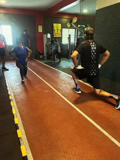 Clients working on lunges on the track, incorporating functional movement into their training routines.