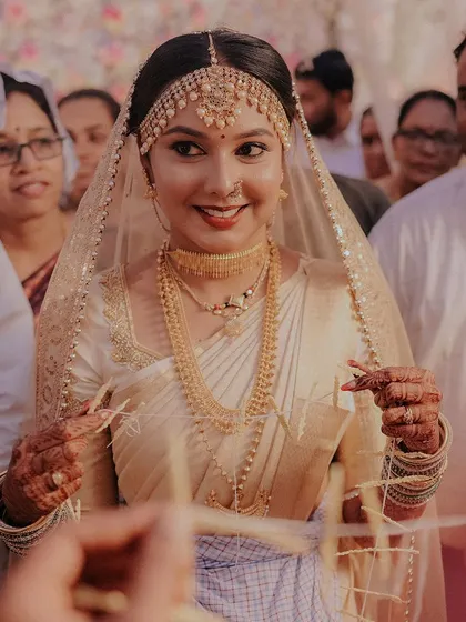 The bride's entrance during a traditional Coorgi ceremony. She looks radiant and happy.