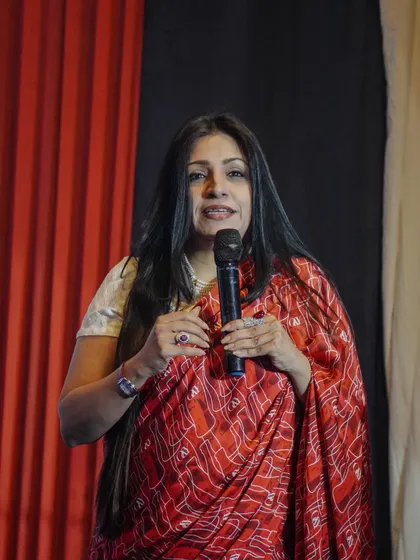 A guest speaker addresses the audience, sharing her experiences in the fashion world.