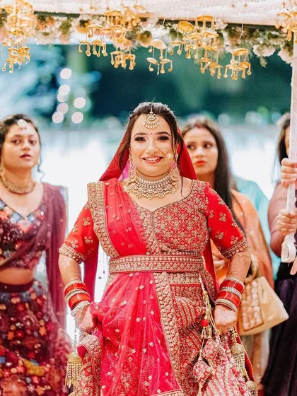 The bride's joyful entrance, dancing her way to the mandap under a beautiful 'phoolon ki chadar'.
