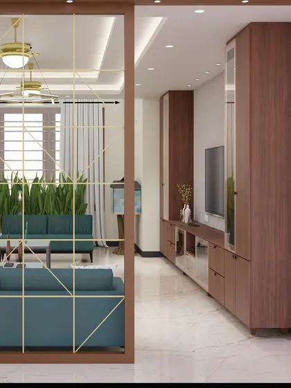 A view through the geometric partition, showing how it stylishly separates the living area while maintaining a sense of connection. The design uses warm wood for the TV unit and lush plants to complete the look.