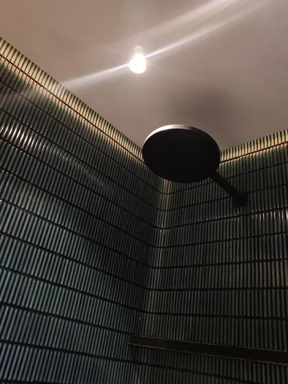 A close-up of a material and lighting mockup on site. We believe in a hands-on process, and testing how materials like these ribbed tiles interact with light is a critical step to achieving the perfect sensory effect.