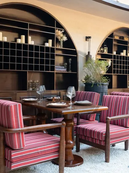 The indoor-outdoor seating at Addoni's, featuring our custom-made chairs with bold, red-striped fabric and solid wood frames. The design was crafted to be both visually striking and durable enough for a high-traffic commercial environment.