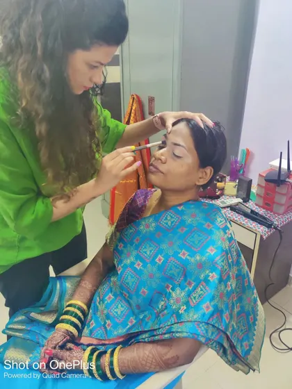 Here I am in action, carefully applying eye makeup. I believe in a collaborative process to create the perfect look for each bride.