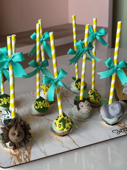 Another view of our jungle themed cake pops, each decorated with a cute ribbon and a "one" tag for a first birthday celebration.