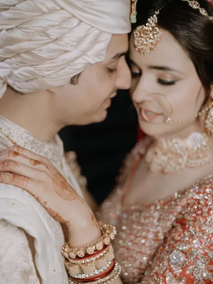 An intimate close-up of Priya and Nishant, their foreheads touching, capturing the deep love and emotion of the wedding day.