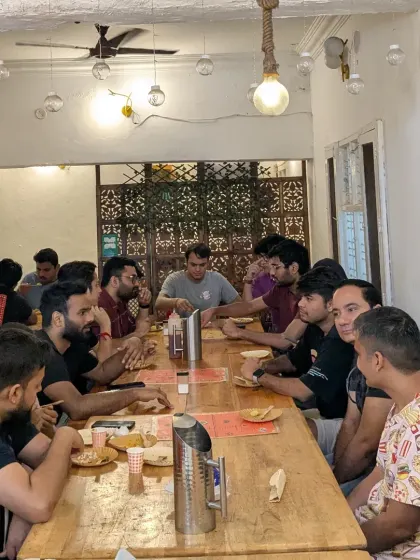 Inside a Poha-Jalebi Club meetup. Strangers become friends over a long table, swapping stories about their connection to this beloved dish. It’s more than just breakfast.