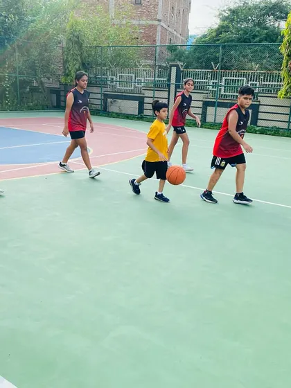 A line of junior players waiting their turn for a dribbling exercise.