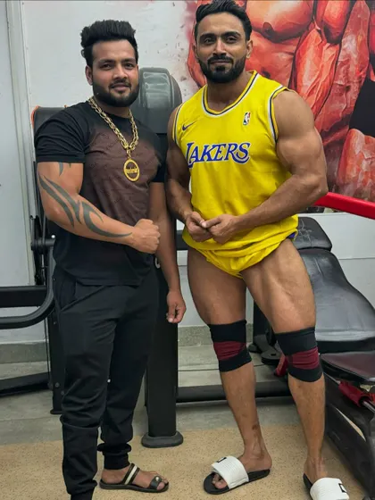 Leg workout done. Posing with a friend after a tough session.