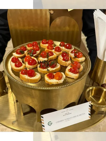 Classic Cherry Tomato Bruschetta served on a beautiful brass tray. The freshness of the tomatoes and basil makes this a timeless and elegant appetizer.