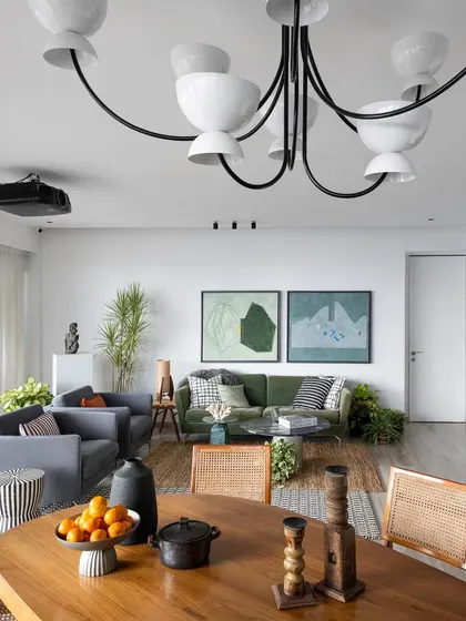 This living and dining area is designed to evoke serenity and a connection with nature. The earthy tones, natural materials like wood and rattan, and abundant plants create a calm, farmhouse-inspired vibe in the heart of the city.