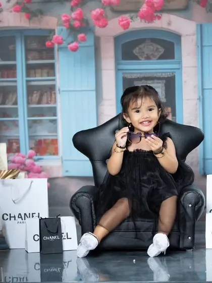 This stylish toddler is showing off her new sunglasses during her Parisian adventure.