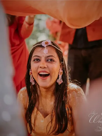 A candid shot of the bride's happiness during the Haldi rituals.
