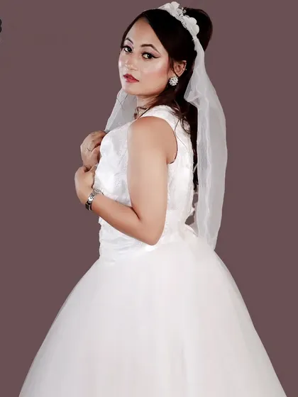 A beautiful pose in a white Christian bridal gown, complete with a veil and tiara.