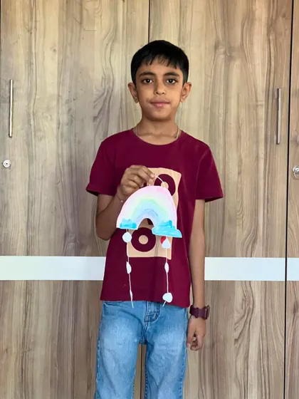 This young man is showing off the pastel rainbow he created. Our crafts are designed to be enjoyed by both boys and girls.