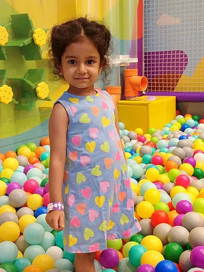 A sweet smile from one of our young guests enjoying the ball pit.