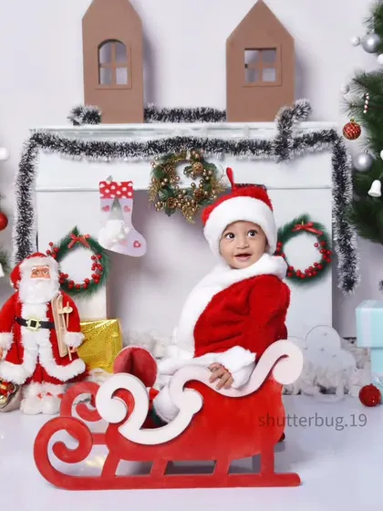 Our little Santa is ready to deliver presents in his sleigh, part of our classic white Christmas setup.