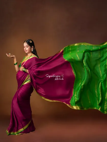 Another angle of the dynamic saree flow, capturing the vibrant colors and textures against a classic studio backdrop.