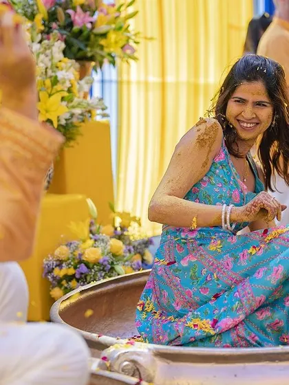 The bride's infectious laughter as she enjoys the Haldi rituals with her groom.
