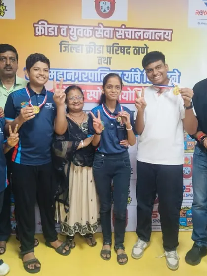 A group of our medal-winning students and their families pose with our director. This photo captures the community and support system that surrounds our young athletes.