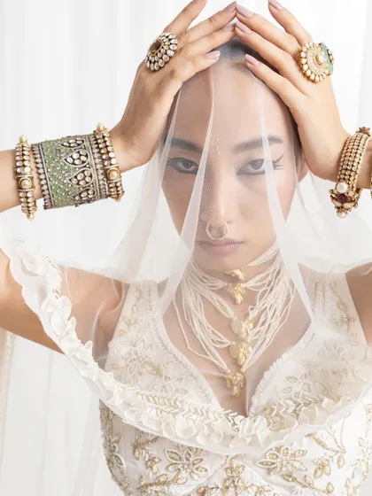 A powerful image showcasing how to layer bridal jewellery. Here, I have combined a statement pearl necklace with bold Polki bangles and rings for a look that is rich and opulent.